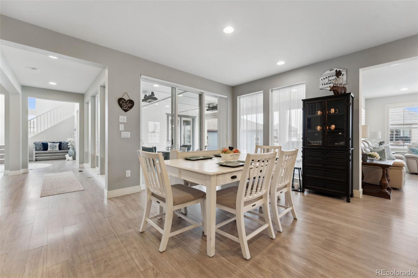 9459 Gore Loop Arvada, CO 80007 - Photo 18 of 50 a view of a dining room with furniture window and wooden floor