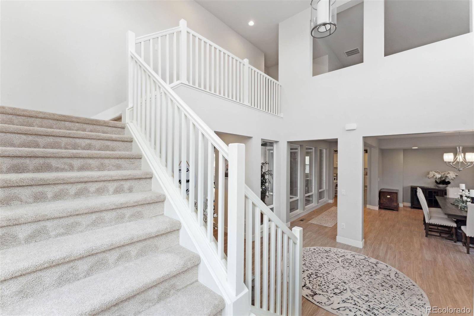 9459 Gore Loop Arvada, CO 80007 - Photo 20 of 50 a view of staircase with lots of frames and couches