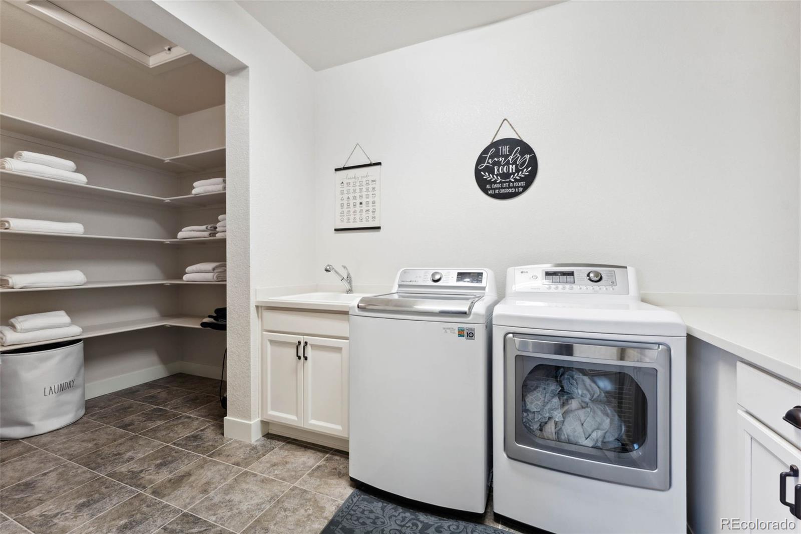 9459 Gore Loop Arvada, CO 80007 - Photo 30 of 50 a view of a storage & utility room with a washer and dryer