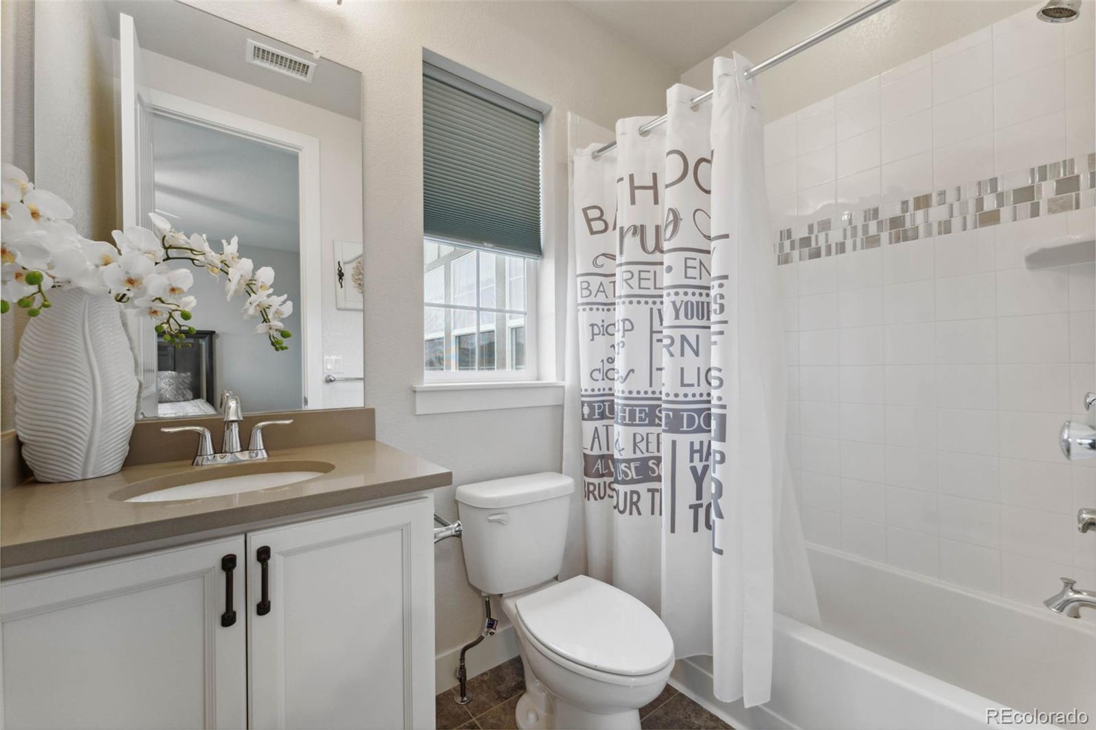 9459 Gore Loop Arvada, CO 80007 - Photo 32 of 50 a bathroom with a sink a toilet and shower