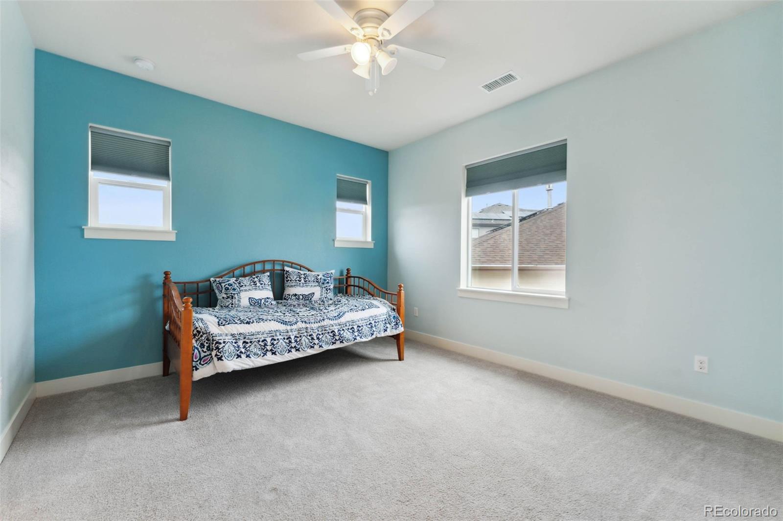 9459 Gore Loop Arvada, CO 80007 - Photo 35 of 50 a bedroom with a bed and a chandelier