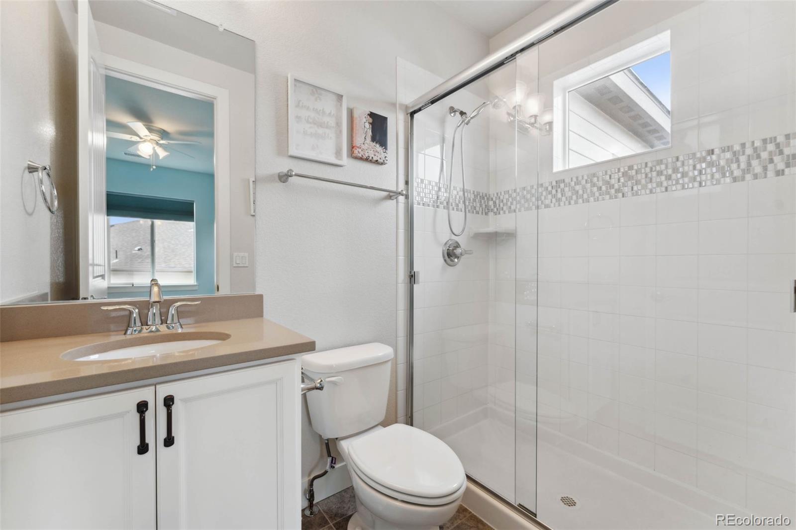 9459 Gore Loop Arvada, CO 80007 - Photo 36 of 50 a bathroom with a sink a toilet and shower