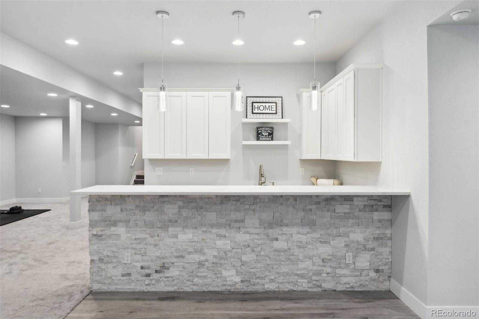 9459 Gore Loop Arvada, CO 80007 - Photo 38 of 50 a large kitchen with kitchen island a sink stainless steel appliances and cabinets