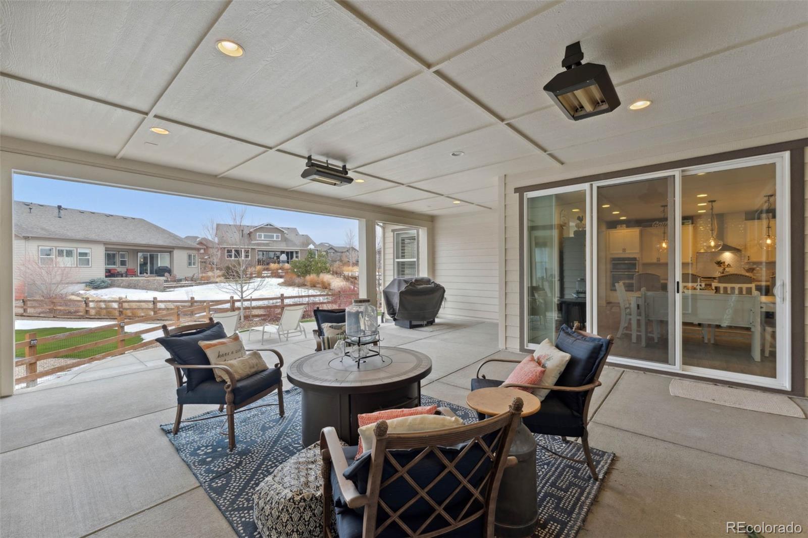 9459 Gore Loop Arvada, CO 80007 - Photo 45 of 50 a view of a dining room with furniture wooden floor and chandelier