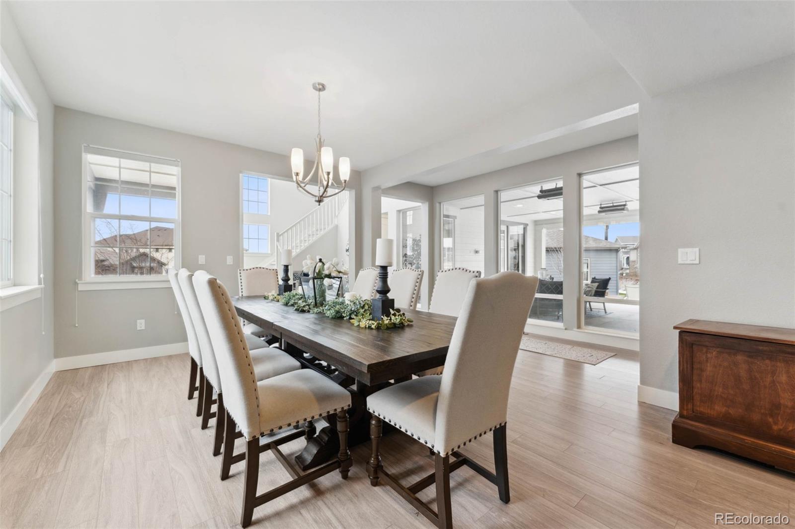 9459 Gore Loop Arvada, CO 80007 - Photo 8 of 50 a view of a dining room with furniture window and wooden floor