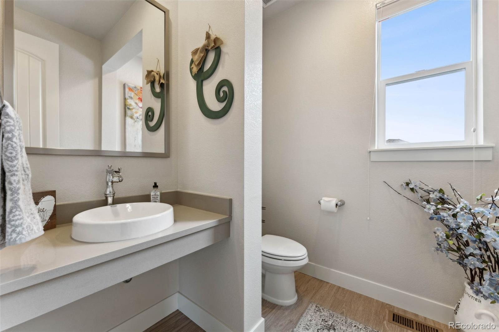 9459 Gore Loop Arvada, CO 80007 - Photo 10 of 50 a bathroom with a toilet sink and mirror