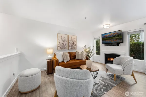 a living room with furniture and wooden floor