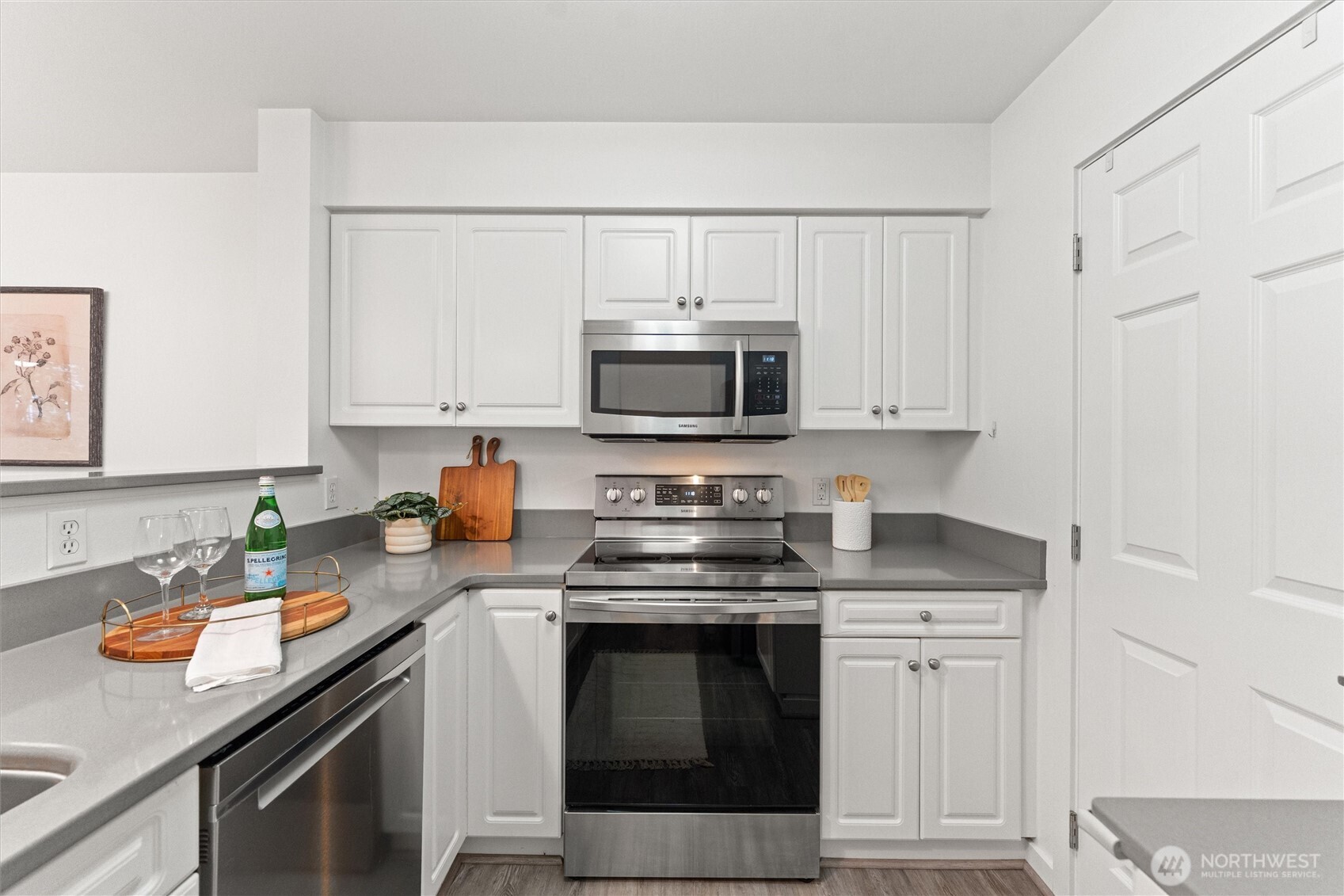 15150 140th Way Southeast, Unit S103 Renton, WA 98058 - Photo 11 of 40 a kitchen with stainless steel appliances granite countertop a stove a sink dishwasher and a microwave