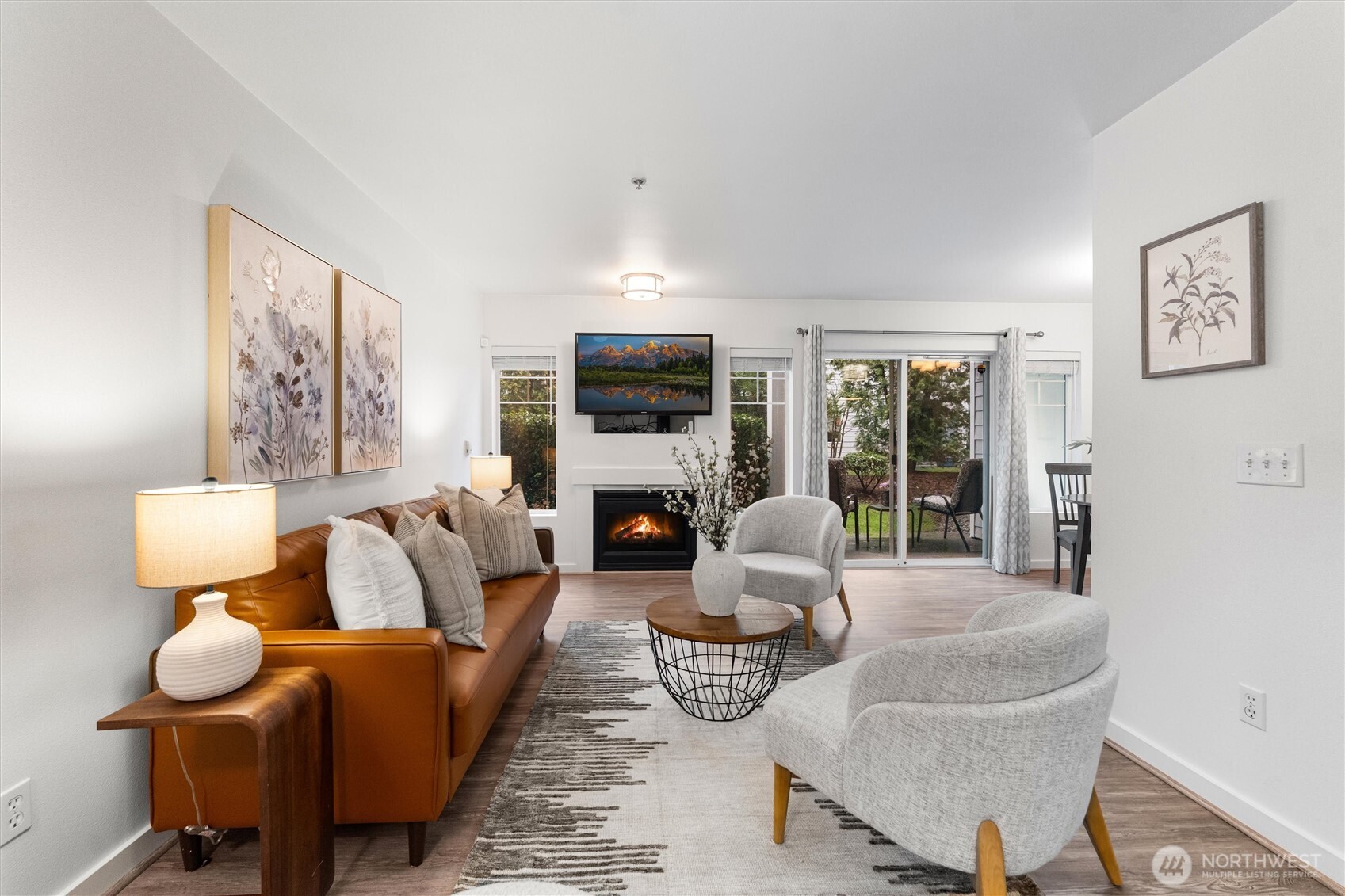 15150 140th Way Southeast, Unit S103 Renton, WA 98058 - Photo 3 of 40 a living room with furniture a fireplace and a flat screen tv