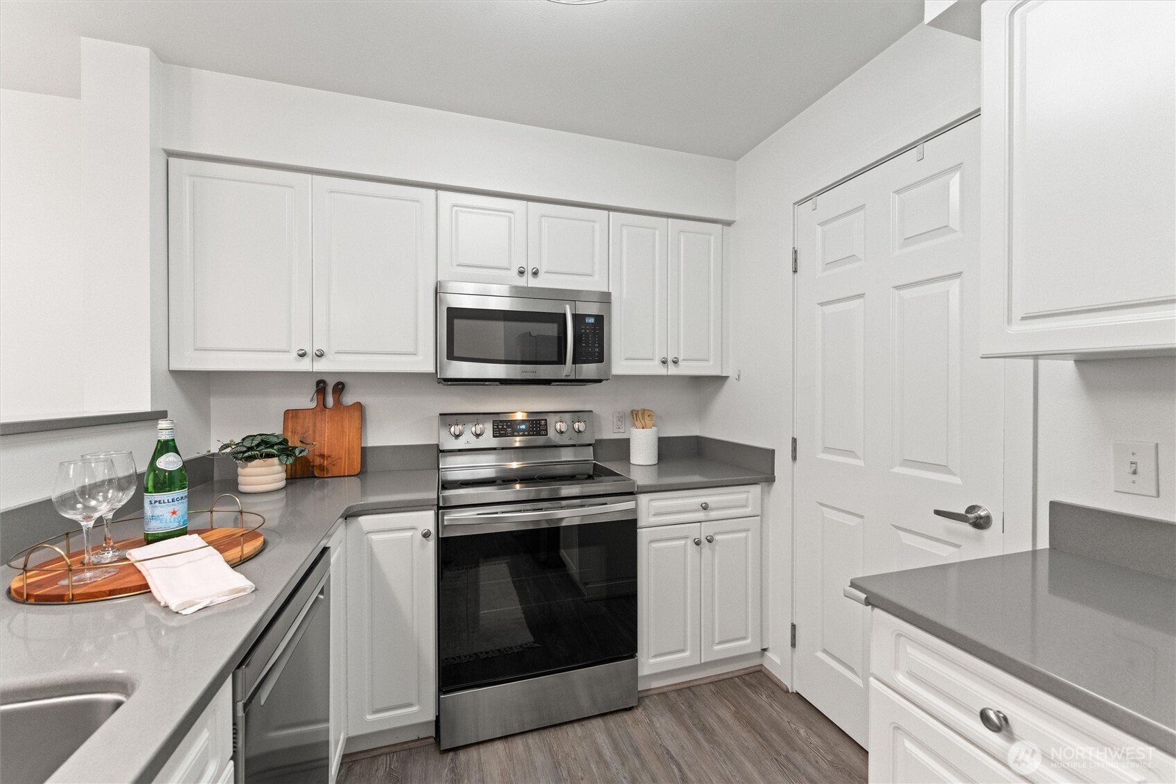 15150 140th Way Southeast, Unit S103 Renton, WA 98058 - Photo 10 of 40 a kitchen with stainless steel appliances a stove microwave and sink