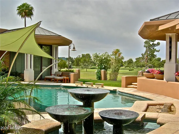 a view of a house with a backyard porch and sitting area