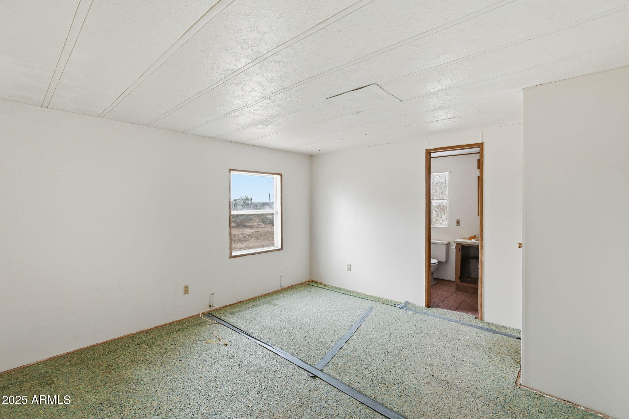 9156 South Thornton Road Casa Grande, AZ 85193 - Photo 11 of 24 a view of an empty room with a window