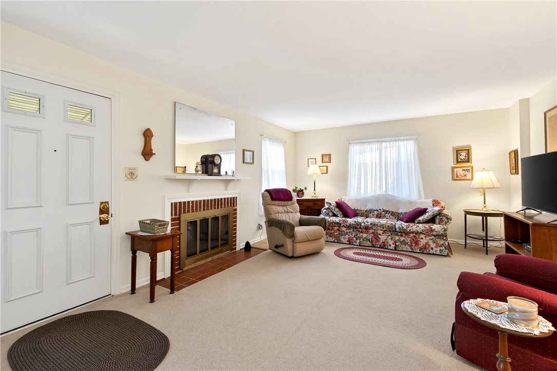 1237 Laurelwood Road Dayton, OH 45409 - Photo 6 of 56 This inviting living room features a fireplace, creating a warm and welcoming atmosphere for all.