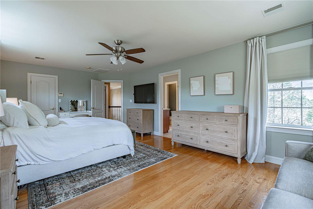 6000 Pond View Terrace Bath, PA 18014 - Photo 37 of 69 Hardwood floors and a large window illuminate this spacious sleeping area, offering a tranquil retreat.