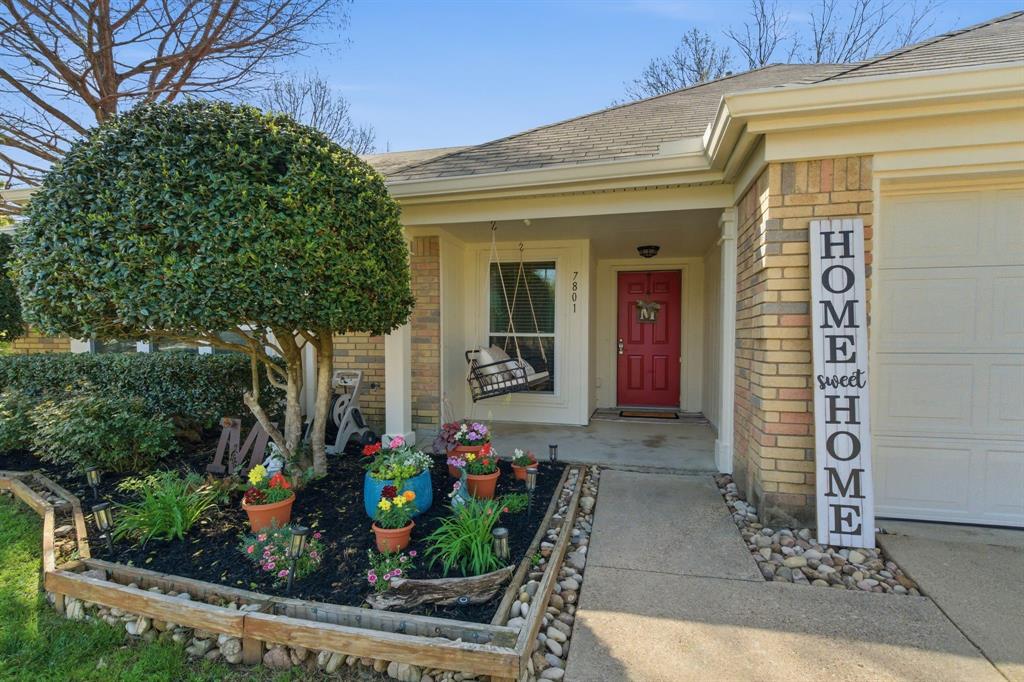 7801 Defender Lane Rowlett, TX 75089 - Photo 4 of 35 Beautiful flower bed and comfy porch
