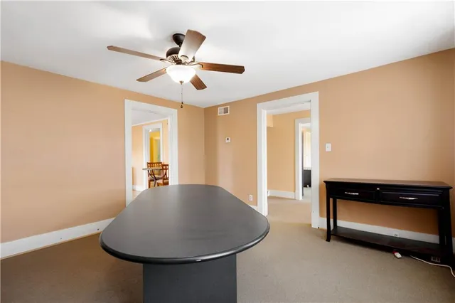 a view of workspace with furniture and wooden floor