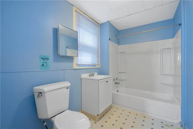 an empty room with closet and wooden door