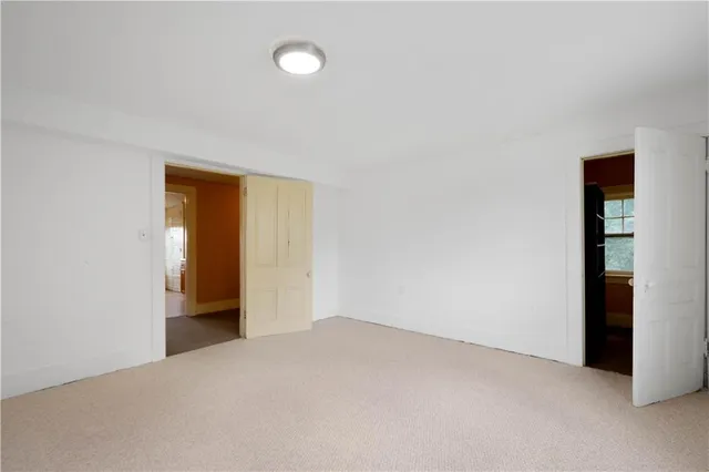 a view of a hallway with wooden floor and furniture