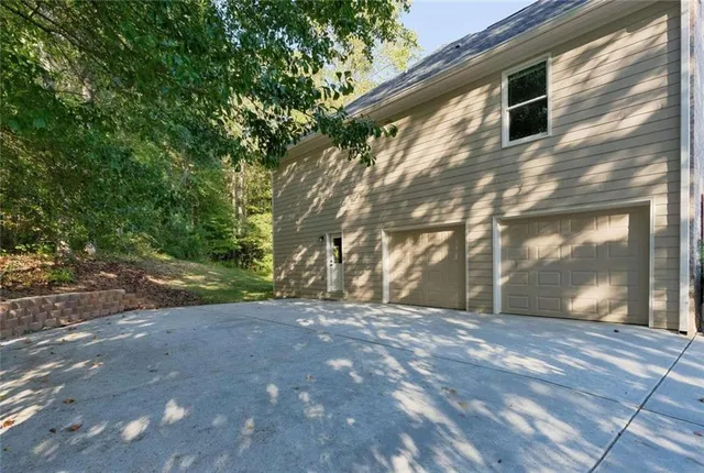 a backyard of a house with large trees