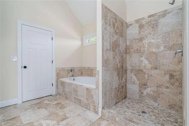 a spacious bathroom with a bathtub and a sink