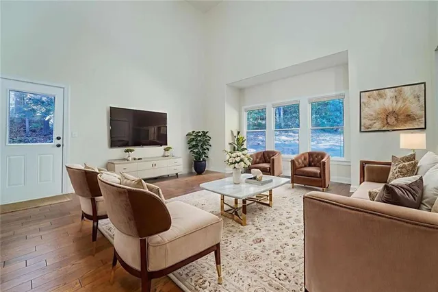 a living room with furniture a rug and a flat screen tv