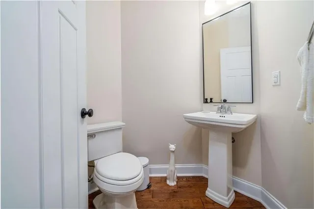 a bathroom with a sink toilet and a mirror