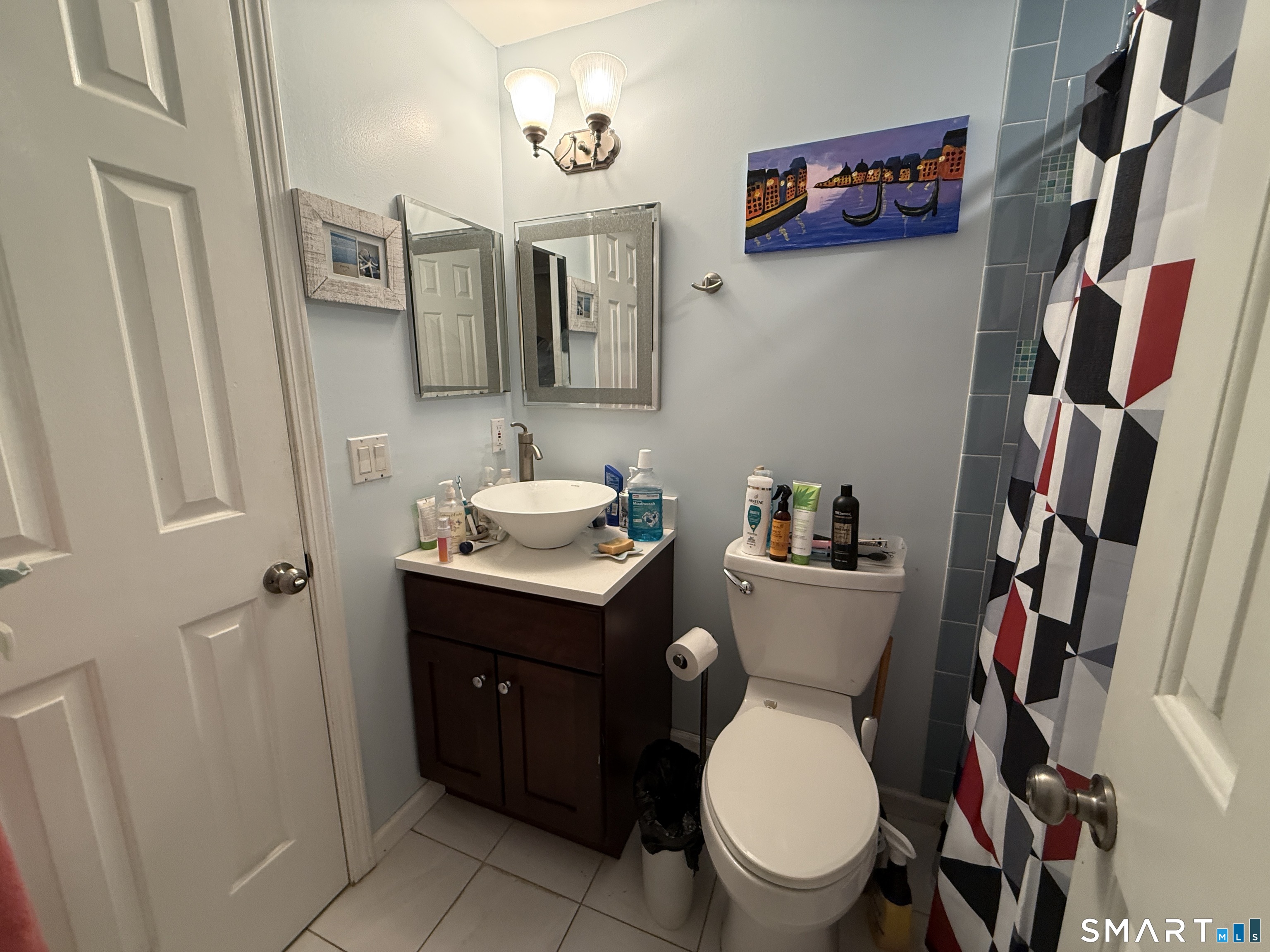 900 Mix Avenue, Unit 68 Hamden, CT 06514 - Photo 14 of 16 a bathroom with a toilet sink and mirror
