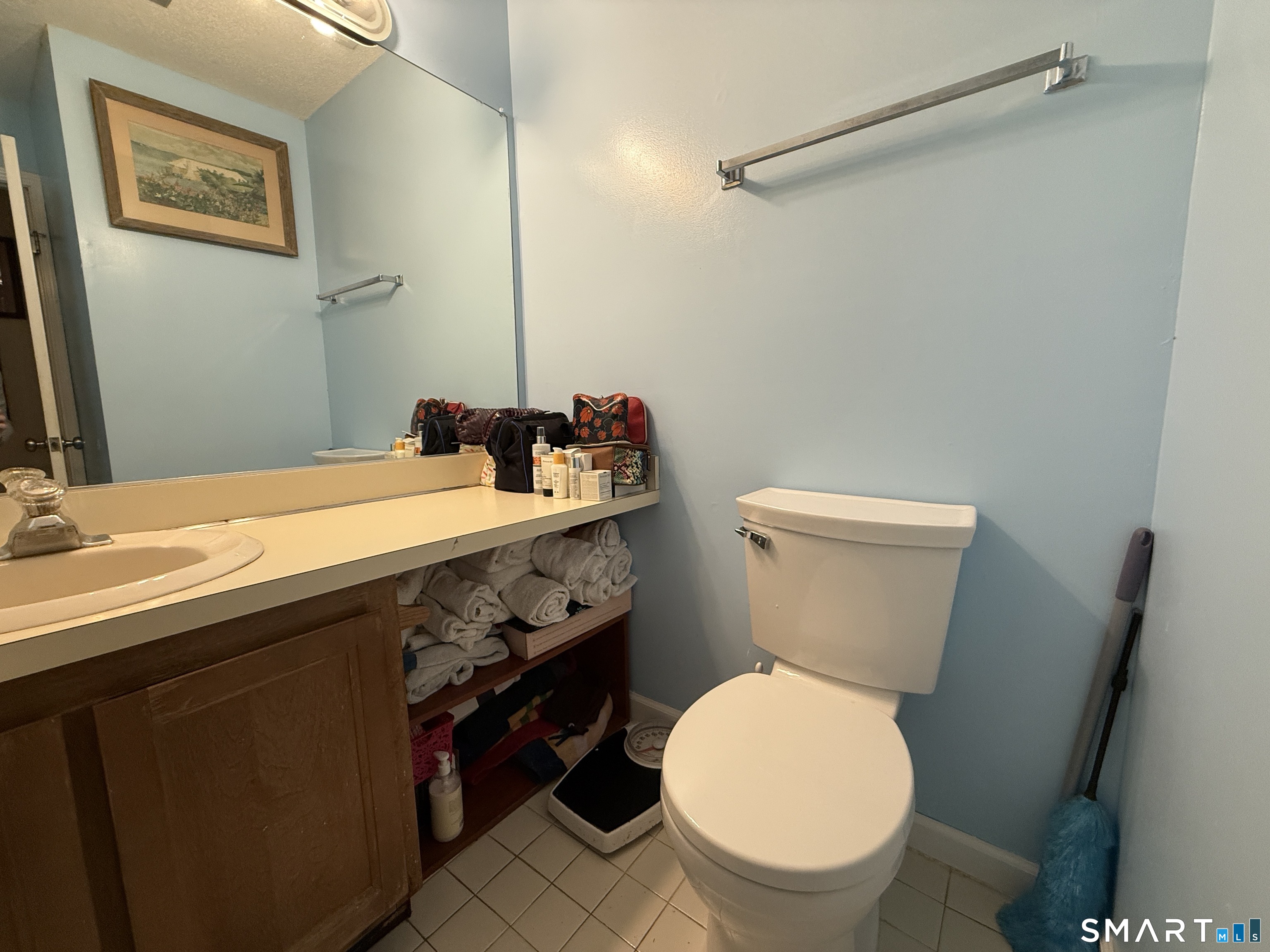 900 Mix Avenue, Unit 68 Hamden, CT 06514 - Photo 15 of 16 a bathroom with a sink a toilet and a mirror