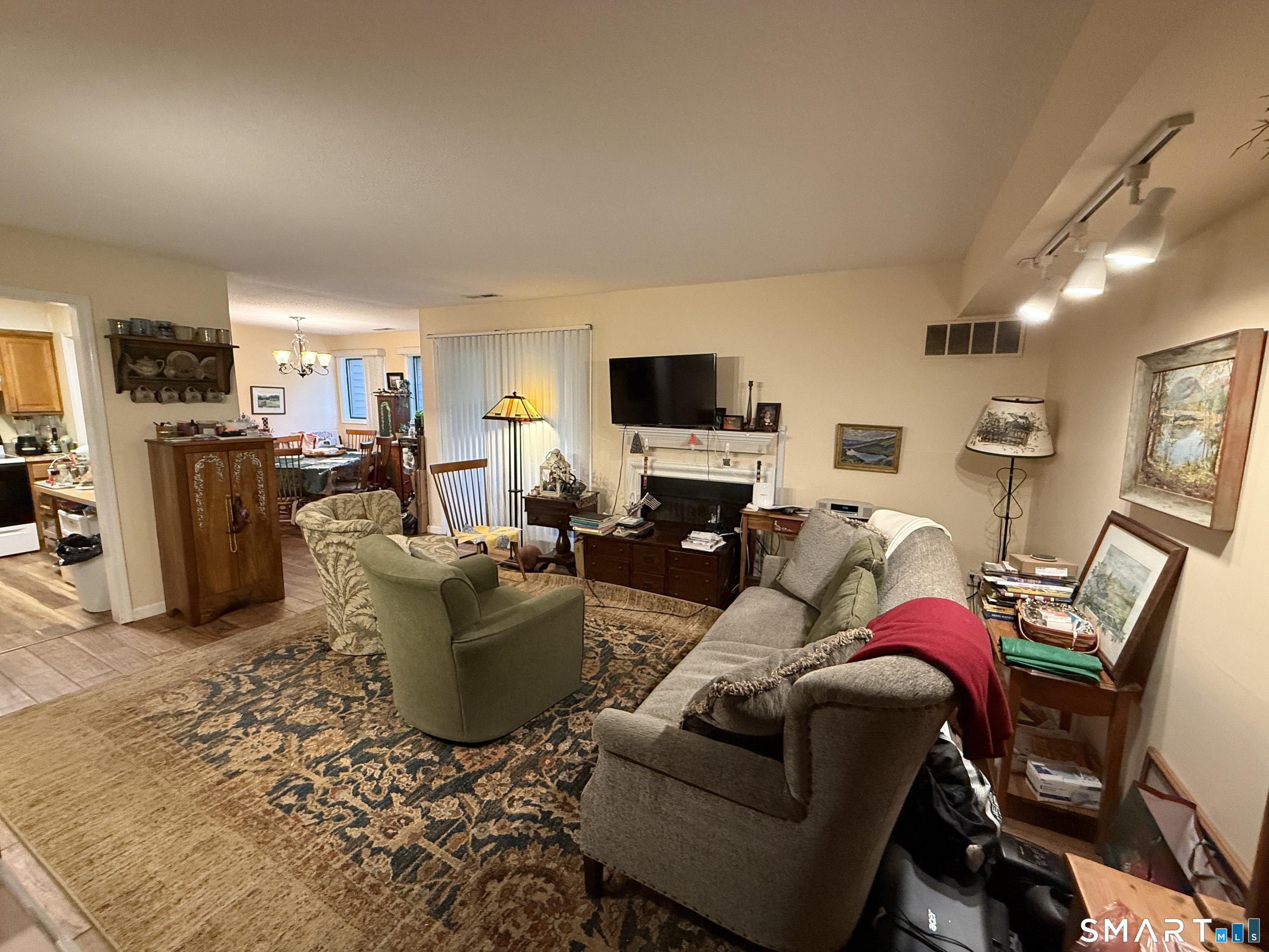 900 Mix Avenue, Unit 68 Hamden, CT 06514 - Photo 3 of 16 a living room with furniture a flat screen tv and a window