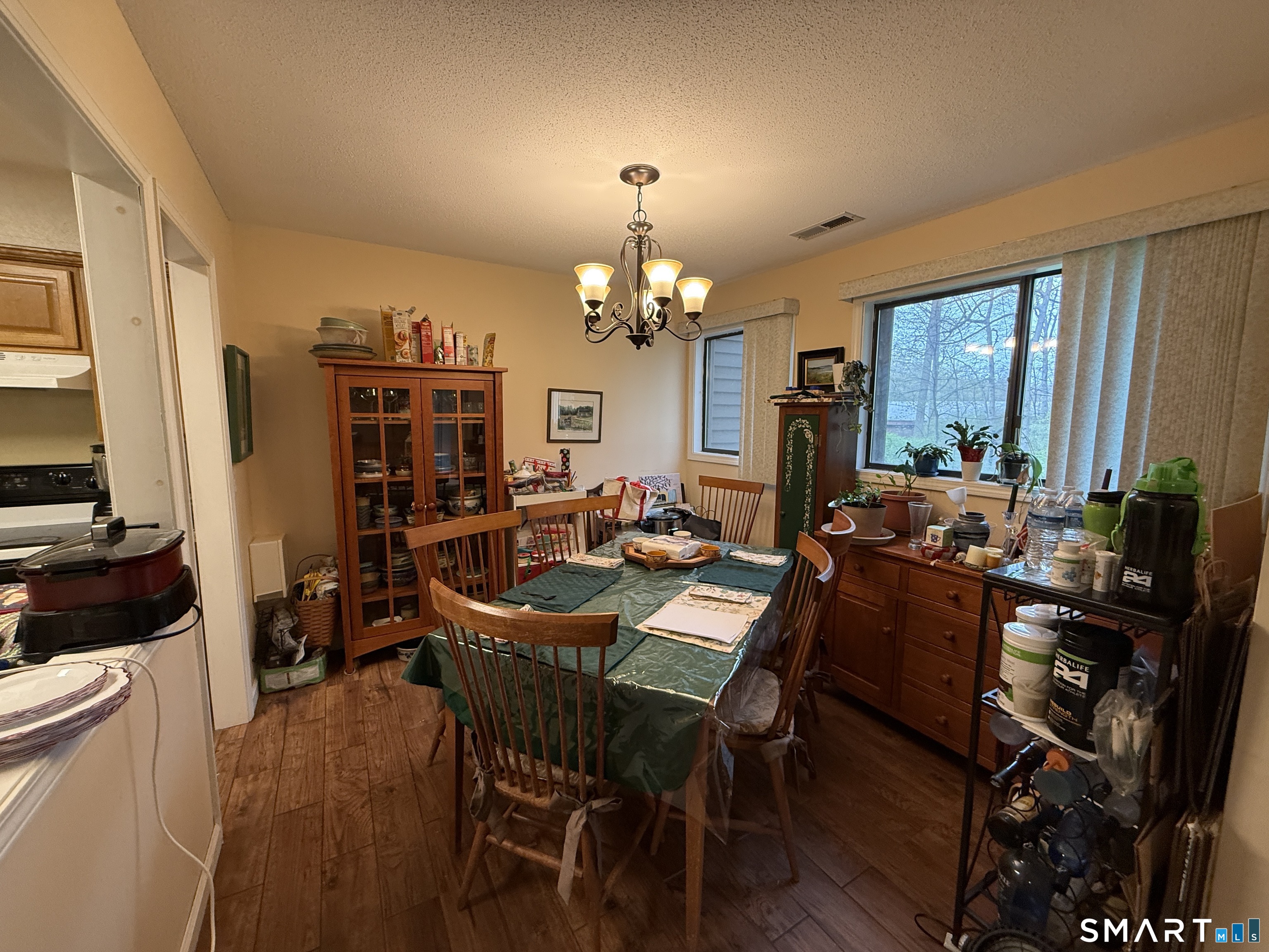 900 Mix Avenue, Unit 68 Hamden, CT 06514 - Photo 6 of 16 a view of a dining room with furniture and a chandelier