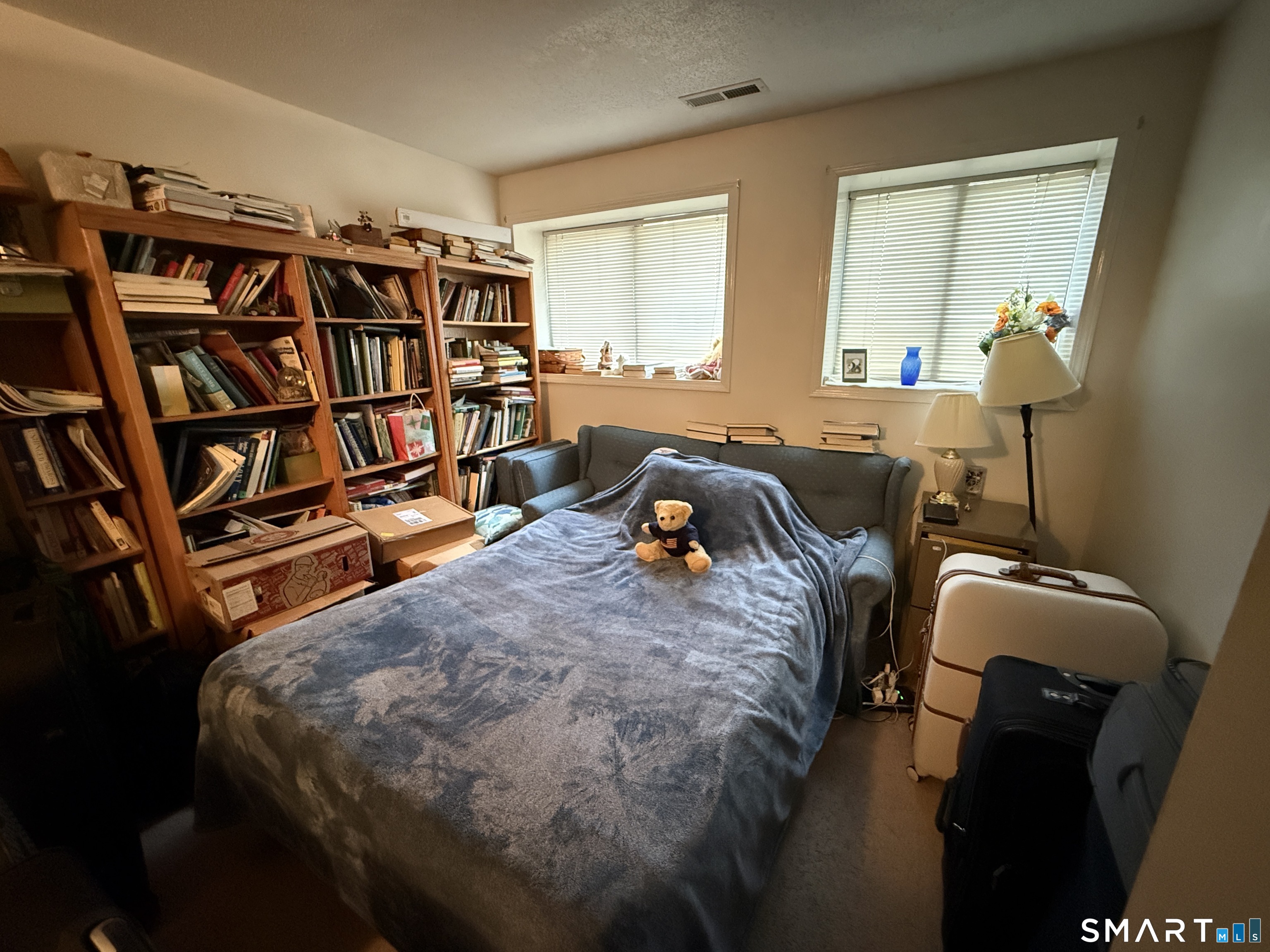 900 Mix Avenue, Unit 68 Hamden, CT 06514 - Photo 10 of 16 a bed room with a bed and a book shelf