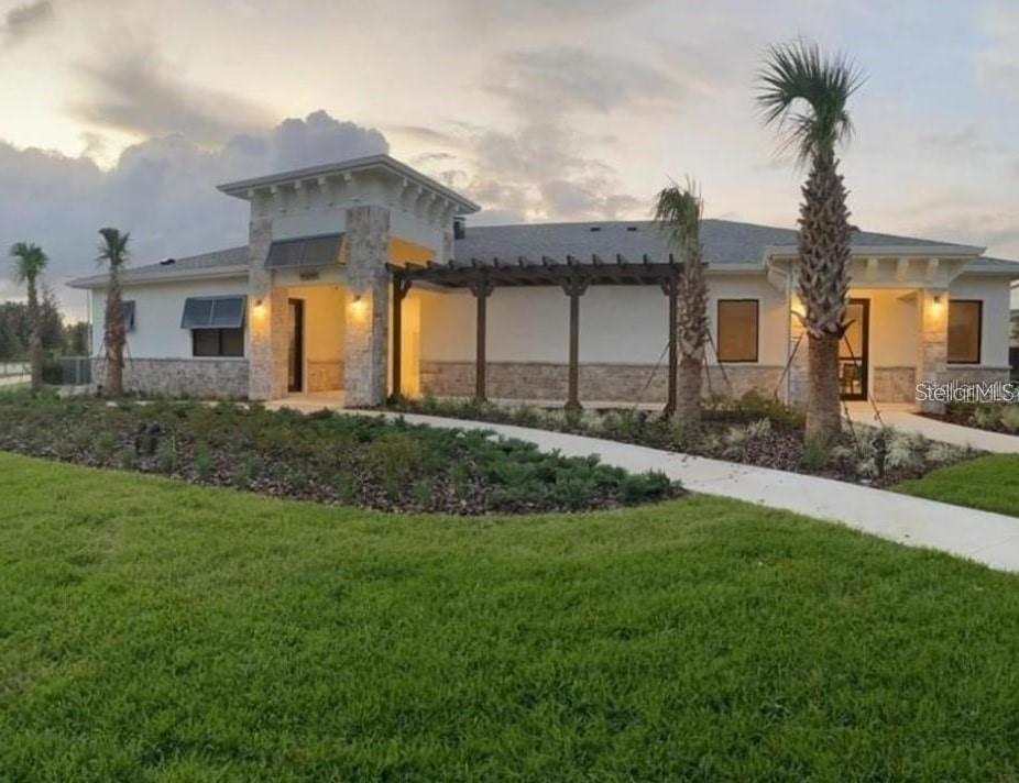 15187 Chapter Way Winter Garden, FL 34787 - Photo 13 of 17 a front view of a house with a garden and yard