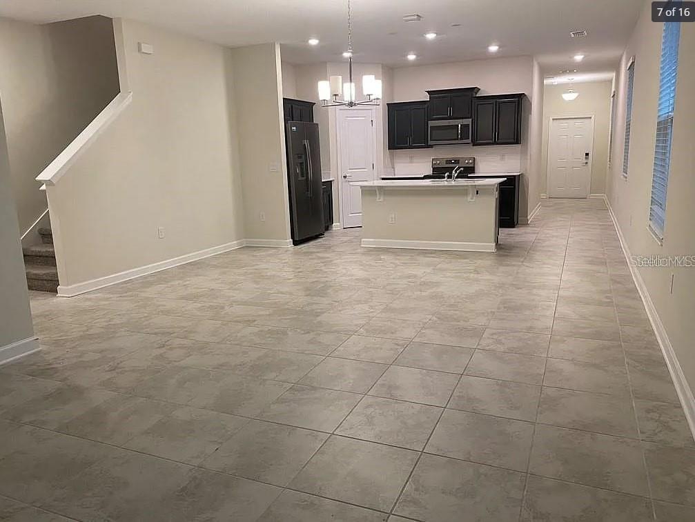 15187 Chapter Way Winter Garden, FL 34787 - Photo 6 of 17 a view of a kitchen with a sink and a refrigerator