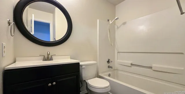 a bathroom with a sink a toilet and a mirror