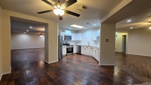 a view of kitchen with cabinets and wooden floor