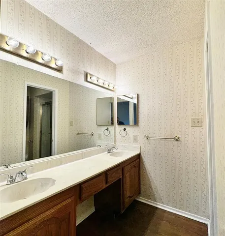 a spacious bathroom with a double vanity sink and mirror