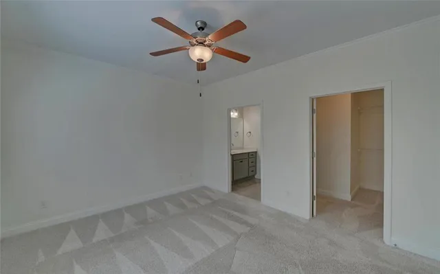 an empty room with a empty space and a ceiling fan