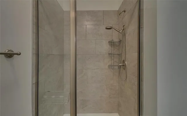 a bathroom with a glass shower door