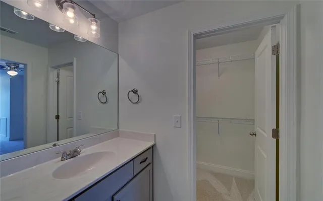 a bathroom with a sink vanity granite and shower