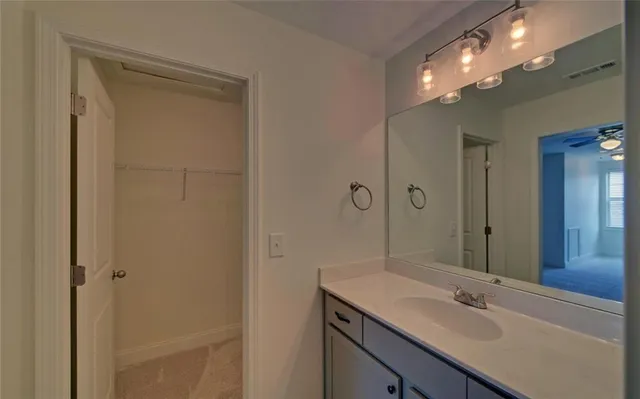a bathroom with a sink a vanity and a mirror