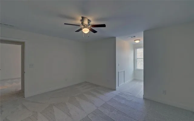 a view of room that has a small kitchen