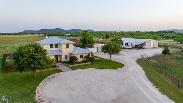 an aerial view of a house with garden space and lake view