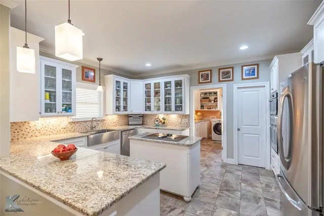 a kitchen with refrigerator and cabinets