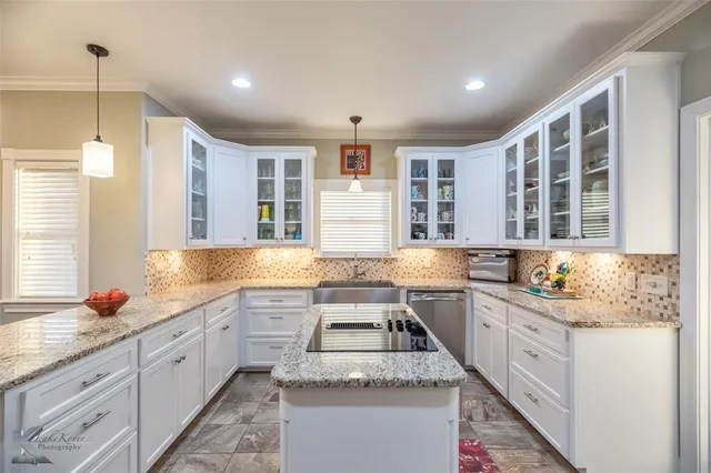 a kitchen with stainless steel appliances granite countertop a sink stove and cabinets