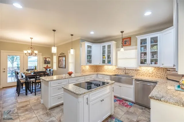 a kitchen with a sink stove and cabinets