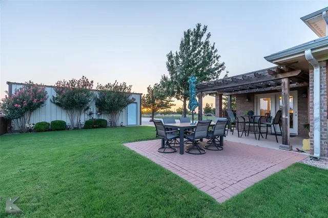 a view of a house with patio and a garden