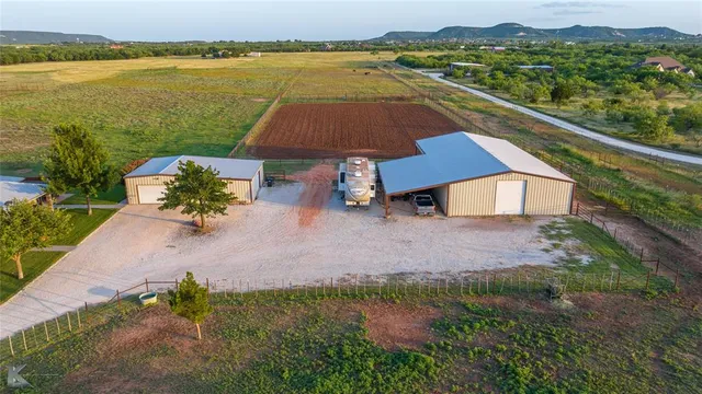 an aerial view of a house with a lake view