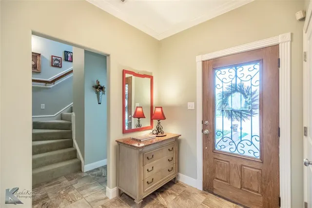 a view of hallway with window and cabinet