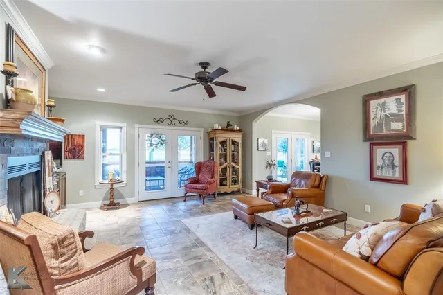 a living room with furniture fireplace and a window
