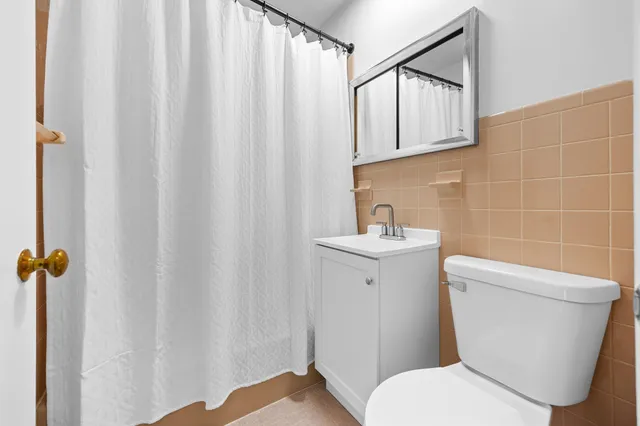 a white toilet sitting next to a bathroom sink